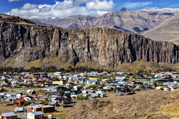 Village with colourful roofs at the foot of impressive cliffs and mountains in the background, the village of El Chalten in Patagonia Argentina