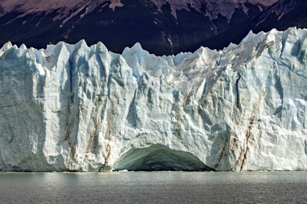 Impressive ice wall of a glacier with clear lines and a blue sky, The glacier of Perito Moreno in Argentina