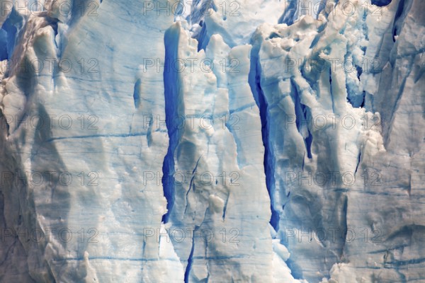 Close-up of a glacier with blue ice texture and visible cracks, The blue ice of the Perito Moreno glacier in Patagonia Argentina