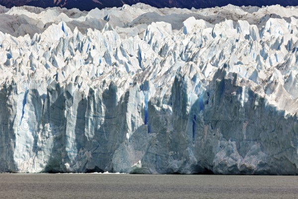 Detailed close-up of an impressive blue glacier wall with striking structures, The Perito Moreno glacier in Argentina
