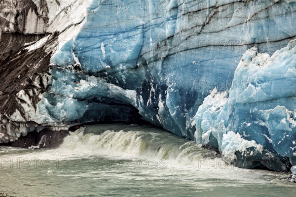 Close-up of a blue-white glacier wall with flowing water, The glacier of Perito Moreno in Argentina