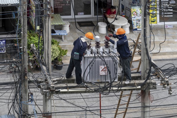 Electricians working on power lines, Pattaya, Thailand
