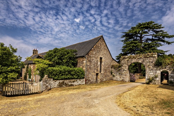 Spacious property with a stone building and archway, surrounded by a rural setting, The Abbey de La Lucerne in Normandy, France