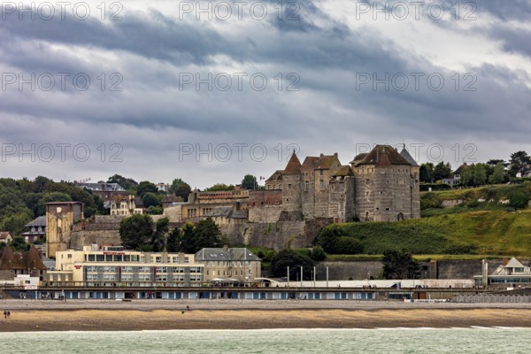 Medieval castle with surrounding town on the beach, under a cloudy sky, historical ambience, Dieppe Castle in Normandy, France