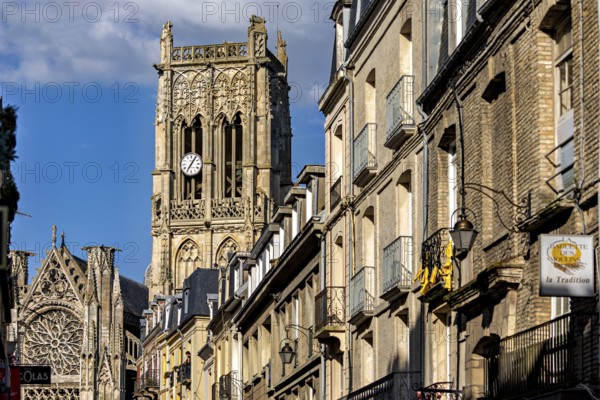 Gothic cathedral with impressive bell tower and stone architecture along the street under a blue sky, Dieppe Cathedral in Normandy, France