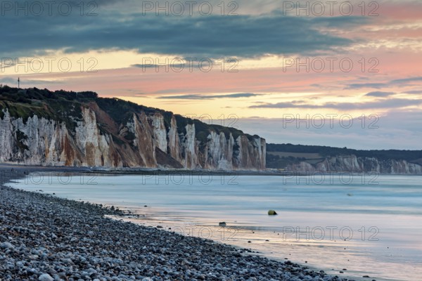 Dramatic cliff landscape with gentle sea coast at sunset with atmospheric sky, The cliffs near Dieppe in Normandy in France