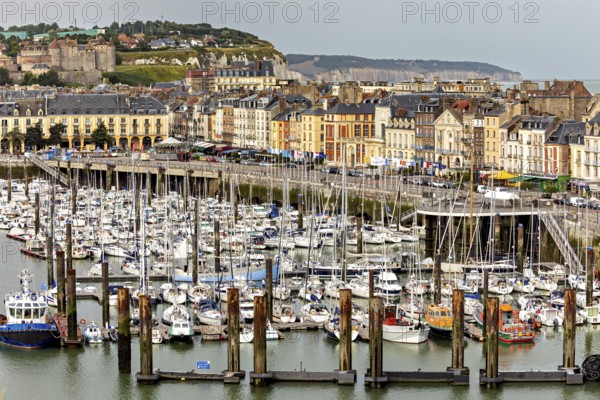 Coastal view of a harbour with numerous boats, lined with historic buildings, The harbour of Dieppe in Normandy, France
