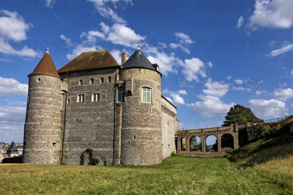 Medieval castle with round towers and stone walls under a blue sky on a green meadow, Dieppe Castle in Normandy, France