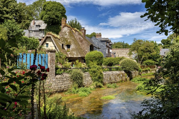 Picturesque village with half-timbered houses and thatched roofs, surrounded by lush nature and a gentle stream, the historic mill village of Veules Les Roses in Normandy, France