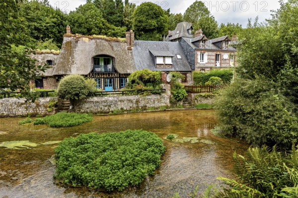 Idyllic river landscape with half-timbered house and lush gardens in the background, the historic mill village of Veules Les Roses in Normandy, France