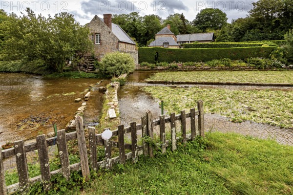 Picturesque landscape with river, old stone bridge and traditional houses in the countryside, the historic mill village of Veules Les Roses in Normandy, France