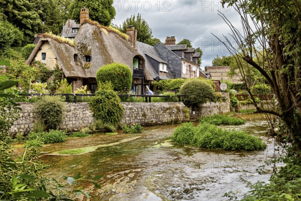 Historic cottages near the river nestled in a magnificent green setting, the historic mill village of Veules Les Roses in Normandy, France
