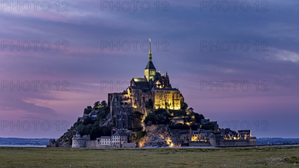 Mont Saint-Michel at sunset with lighting and coloured sky, Mont Saint Michel in Normandy, France