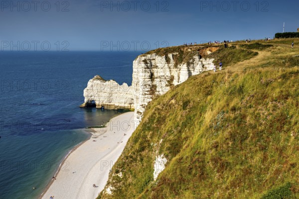 Panoramic view of the coastline with green cliffs and blue sea in sunny weather, The cliffs and alabaster coast of Etretat in Normandy France