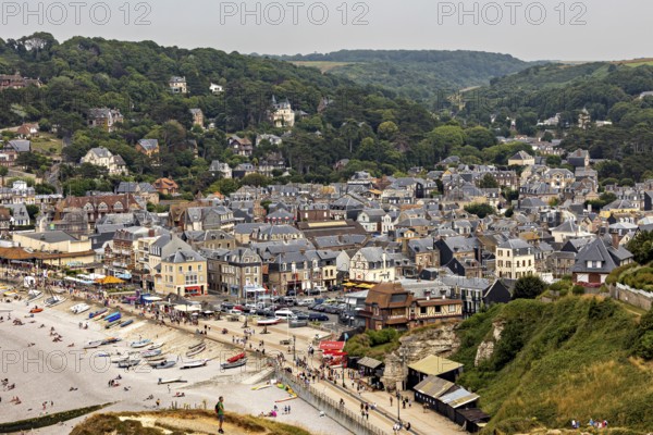 Aerial view of a town on the coast with beach and many buildings, Etretat in Normandy, France