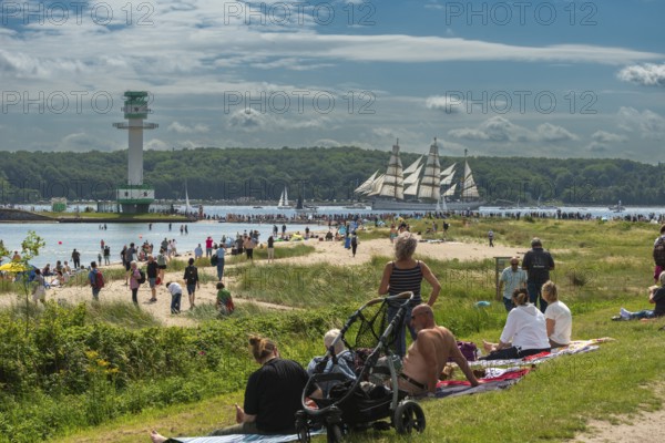 Windjammer parade 2025 on the Kiel Fjord at the end of Kiel Week, tall ships, three-master, sail training ship Gorch Fock, spectators, Falkenstein beach life, lighthouse, summer weather, sunshine, forest, Kiel, Schleswig-Holstein, Germany