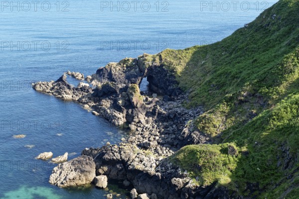 Rocky coast and rock gate on the south-east coast near the southern tip of Cornwall on the English Channel. Cadgwith, Cornwall, South West England, Great Britain