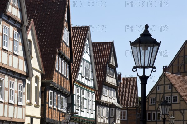 Street with half-timbered houses and historic street lamp in the old town centre, Celle, Lower Saxony, Germany