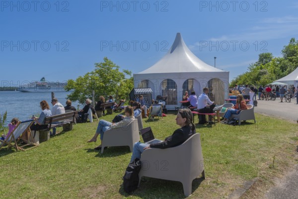 Waterkant Festival 25 in front of Kiel Week 2025 on the MGF 5 site on the Kiel Fjord, annual meeting place for founders of start-up companies with innovative ideas for new technologies, ecology and society, workshops and exhibitions, break and outdoor discussion, cruise ship Amadea, Kiel Holtenau, Schleswig-Holstein, Germany