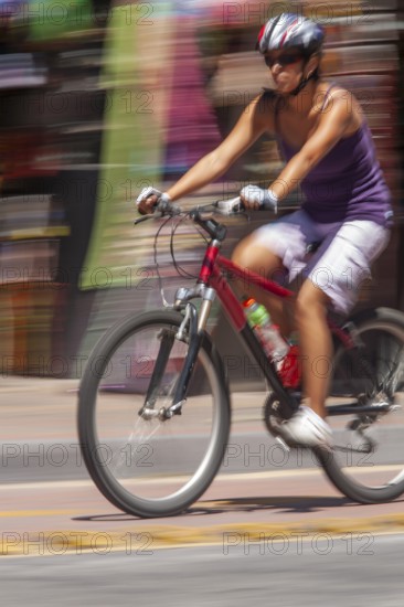 Woman riding a bicycle, Photo with motion blur, City of Quito, Pichincha province, Ecuador, South America