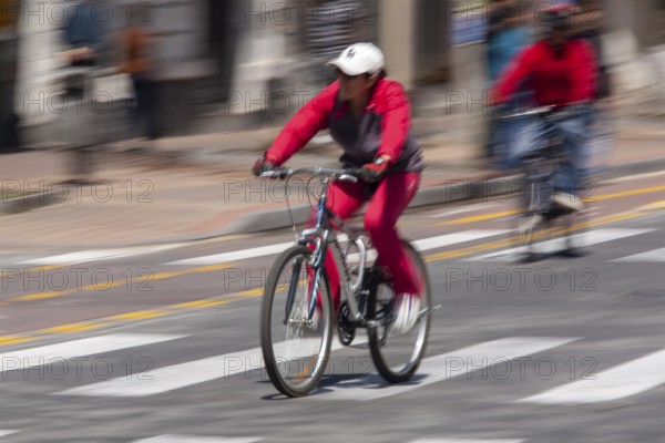 Woman riding a bicycle, Photo with motion blur, City of Quito, Pichincha province, Ecuador, South America