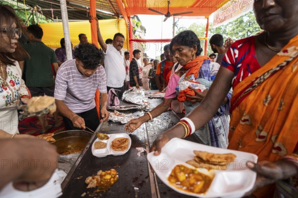Devotees throng to have food as they arrives to visit Kamakhya Temple during Ambubachi Mela, in Guwahati, India on June 22, 2025. The Ambubachi Mela is one of the most spiritually significant and culturally unique festivals in India