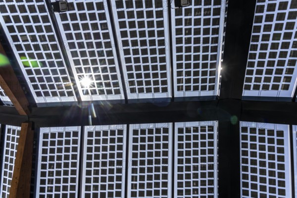 Transparent solar roof of the electric charging station on the site of the former Lohberg colliery in Dinslaken, operated by Fastned, uses electricity from wind and solar power, fast-charging stations, North Rhine-Westphalia, Germany