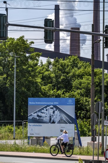 Construction site sign for thyssenkrupp Steel's first direct reduction plant, the climate-neutral steel production project, at the existing steelworks in Duisburg-Farn, pig iron production without a conventional blast furnace but using hydrogen, due to go into operation by the end of 2027, North Rhine-Westphalia, Germany