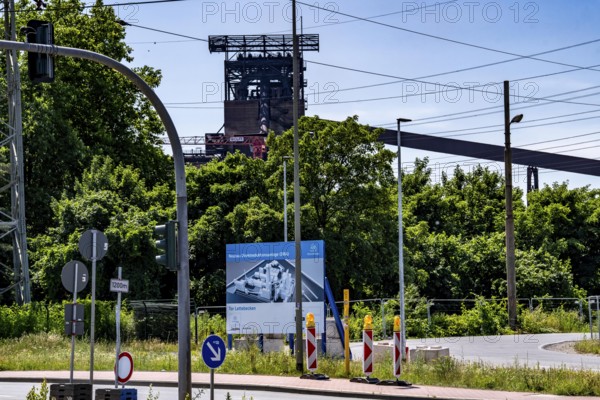 Construction site sign for thyssenkrupp Steel's first direct reduction plant, the climate-neutral steel production project, at the existing steelworks in Duisburg-Farn, pig iron production without a conventional blast furnace but using hydrogen, due to go into operation by the end of 2027, North Rhine-Westphalia, Germany