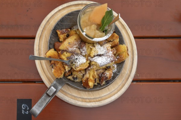 Kaiserschmarrn with apple sauce served in a small pan, Franconia, Bavaria, Germany