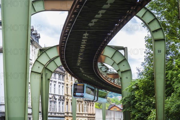 The Wuppertal suspension railway runs through Vohwinkel in front of buildings from the Wilhelminian era near the Hammerstein stop in Wuppertal, Germany