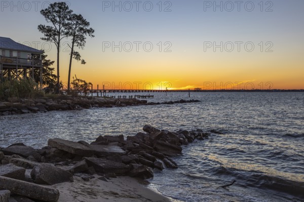 Sunset over the railroad bridge across Bay of Saint Louis from Henderson Point in Pass Christian, Mississippi