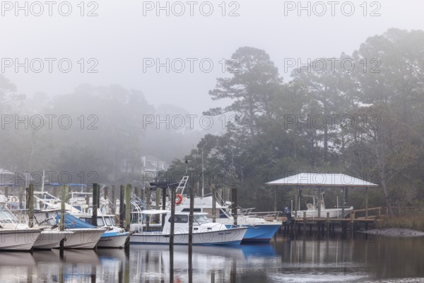 Private fishing boats in the harbor at Ocean Springs, Mississippi on a foggy morning