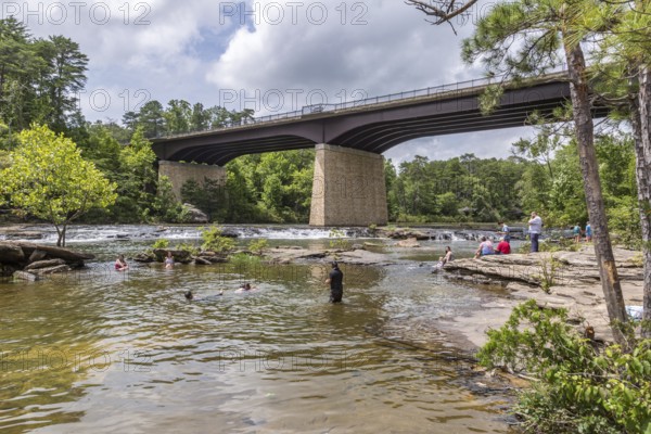 People playing on the rocks under the Little River Falls Bridge in Little River Canyon Falls Park near Ft. Payne, Alabama