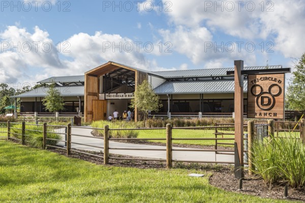 Family entering the Tri-Circle-D Ranch horse stables in the Fort Wilderness Campground and Resort at Disney World in Orlando, Florida