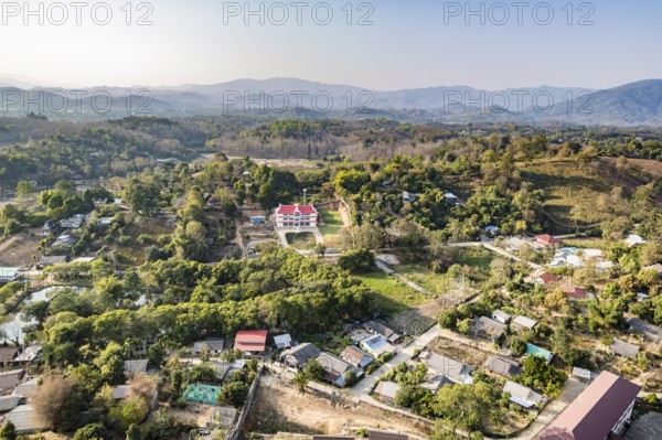 View from the top of the Guan Yin (Goddess of Mercy) statue at Wat Huay Pla Kang Temple in Chiang Rai province of Northern Thailand shows the surrounding rural countryside