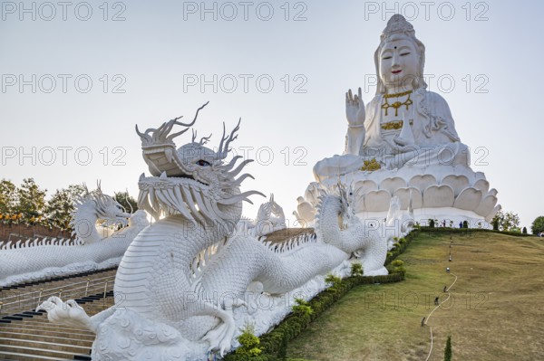 Chinese dragons line the steps up to the Guan Yin (Goddess of Mercy) statue at Wat Huay Pla Kang Temple in Chiang Rai province of Northern Thailand