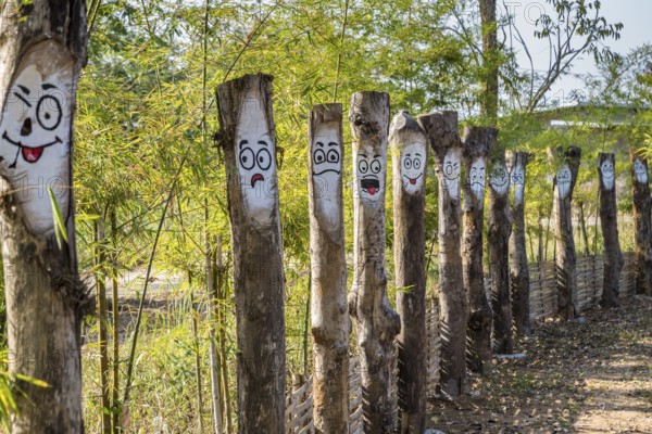 Walkway at the Akha Cottage coffee shop and restaurant in Chiang Rai Thiland asks What is your mood today? and has painted faces with differerent expressions of moods