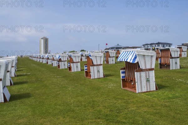 Beach chairs on the green beach, high-rise building, Büsum, North Sea, Schleswig-Holstein, Germany