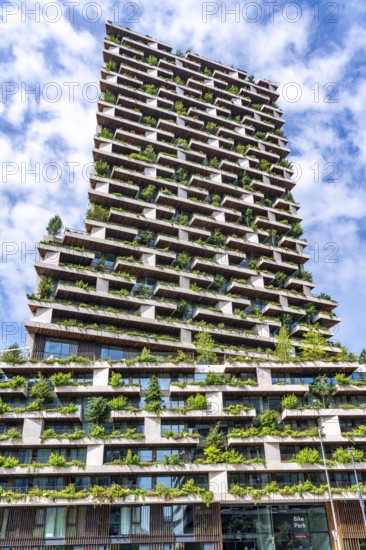 Wonderwoods residential tower, one of 2 green buildings, in Utrecht in the new Healthy Urban Quarter, at the central station, 105 metres high with 30 floors, Tower II, over 360 trees and over 9600 shrubs and flowering plants native to the region, all irrigated with collected rainwater, sponge city principle and monitored with sensors, Utrecht, Netherlands