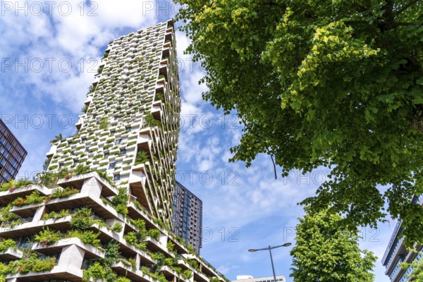 Wonderwoods residential tower, one of 2 green buildings, in Utrecht in the new Healthy Urban Quarter, at the central station, 105 metres high with 30 floors, Tower II, over 360 trees and over 9600 shrubs and flowering plants native to the region, all irrigated with collected rainwater, sponge city principle and monitored with sensors, Utrecht, Netherlands