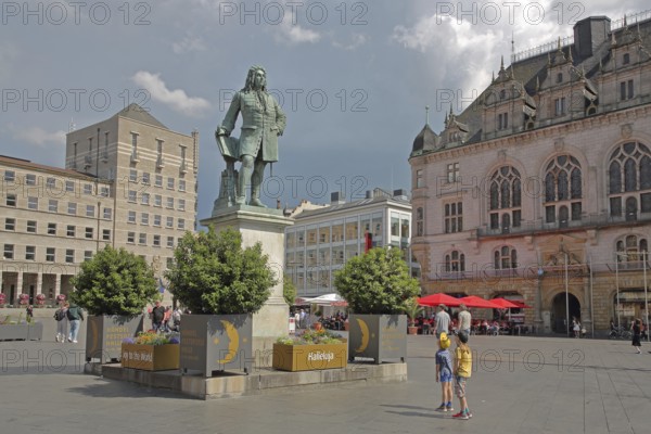 Sculpture Handel Monument by Hermann Heidel 1859, George Frideric Handel, inscription, Hallelujah, hymn of praise, children, spectators, admire, marvel, look at, look up, Ratshof, neo-Gothic town hall, pedestrian zone, Handel Monument, market square, Halle an der Saale, Saxony-Anhalt, Germany