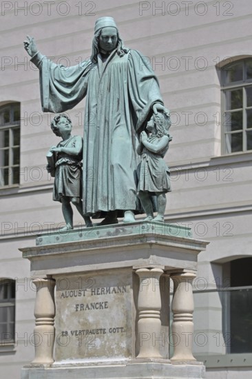 Monument to theologian, pedagogue and poet, August Hermann Francke, man with two children, protect, protect, care, gesture, arm, high, above, bless, hymn writer, interaction, Halle an der Saale, Saxony-Anhalt, Germany
