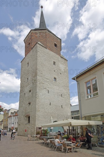 Hallescher Turm built in 1452, historic town tower, street pub, with people, Hallescher Turm, Köthen, Saxony-Anhalt, Germany