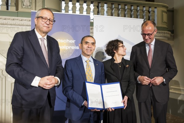Thomas Mirow (Chairman of the Board of the German National Foundation), Ugur Sahin and Özlem Türeci (founders of Biontech SE) and Friedrich Merz (Chancellor of the Federal Republic of Germany) at the award ceremony for the German National Prize 2025 in the Französische Friedrichstadtkirche, Berlin, on 10 June 2025