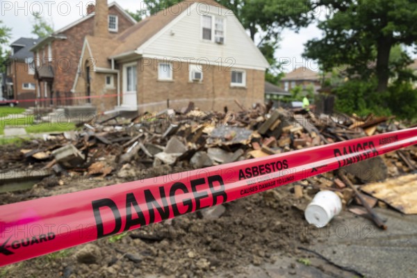 Detroit, Michigan - Signs warn of asbestos danger where a house was demolished. The house had been heavily damaged by fire a year earlier and was a neighborhood eyesore