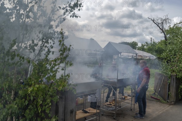 Heavy smoke at the sausage grill stations at the Backofenfest, Kleingeschaidt, Middle Franconia, Bavaria, Germany