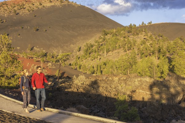 Couple walking on pathway, Sunset Crater Volcano National Monument, Flagstaff, Arizona, USA