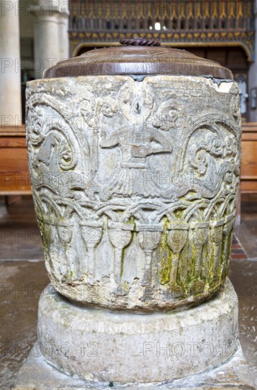 Historic baptismal font inside village parish church of Saint James, Avebury, Wiltshire, England, UK