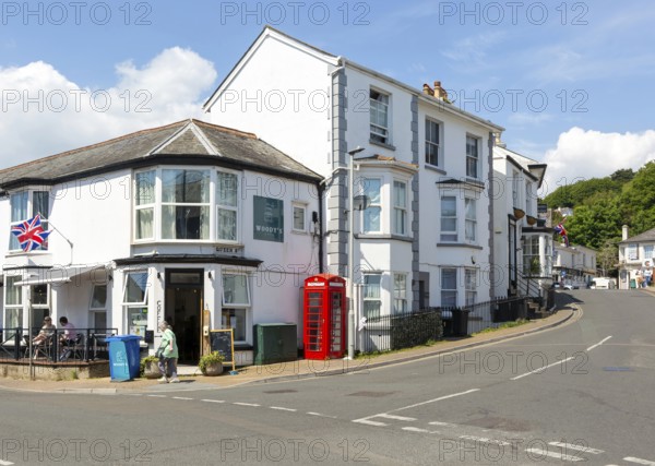 Historic buildings old red telephone box, Woody's cafe, Queen Street, Dawlish, south Devon, England, UK